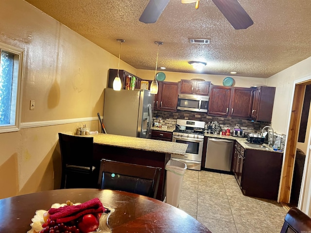 kitchen featuring visible vents, appliances with stainless steel finishes, ceiling fan, and a sink