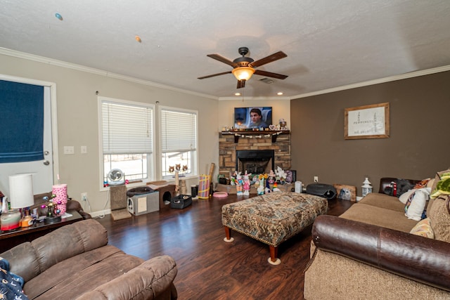 living room featuring a ceiling fan, ornamental molding, wood finished floors, and a stone fireplace