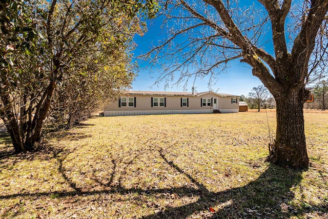 rear view of house with a yard