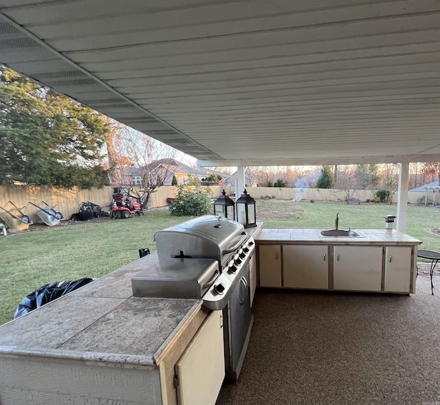 view of patio featuring a fenced backyard, a sink, and area for grilling