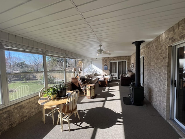 sunroom featuring a wood stove