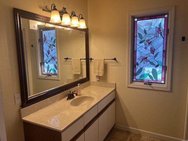 bathroom featuring tile patterned flooring, vanity, and baseboards