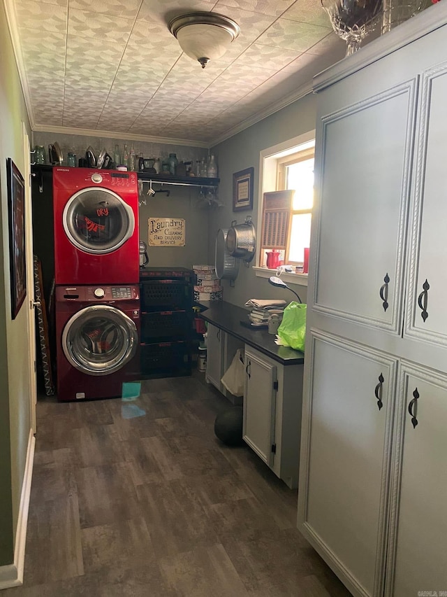 washroom with stacked washer and dryer, cabinet space, ornamental molding, and wood finished floors