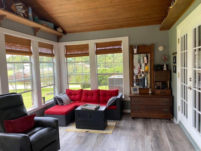 living room featuring lofted ceiling, wood finished floors, and wood ceiling