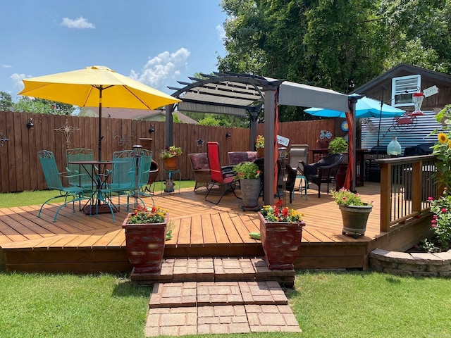 deck featuring a fenced backyard, a pergola, and outdoor dining space