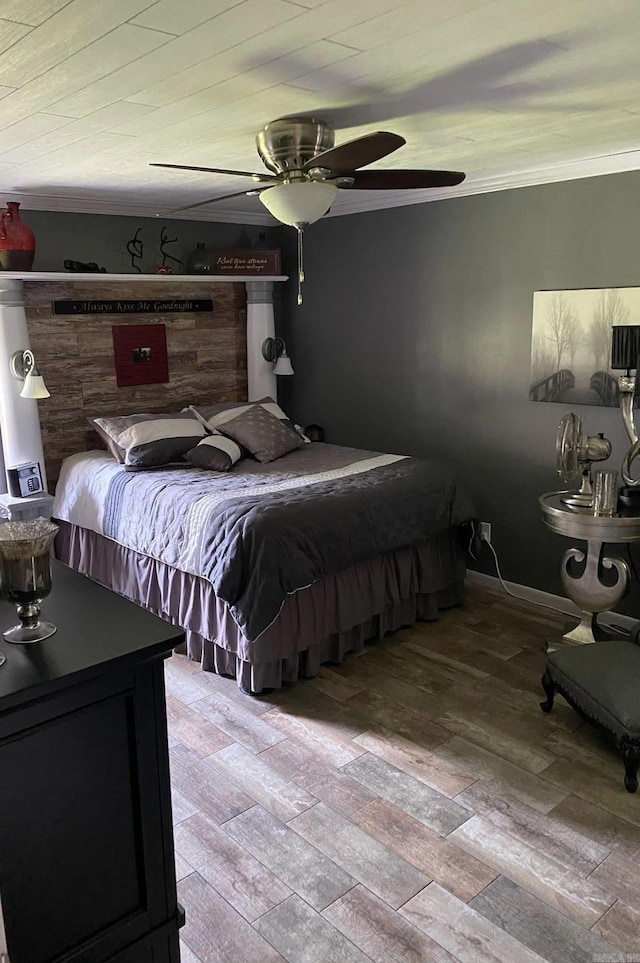 bedroom featuring ornamental molding, wood finished floors, and a ceiling fan