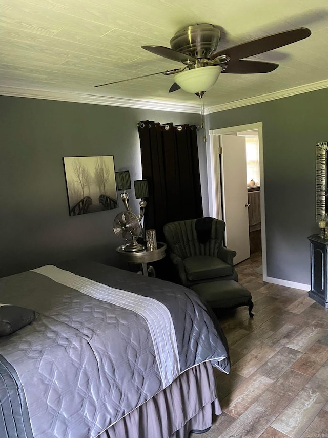 bedroom featuring baseboards, a ceiling fan, wood finished floors, ensuite bathroom, and crown molding