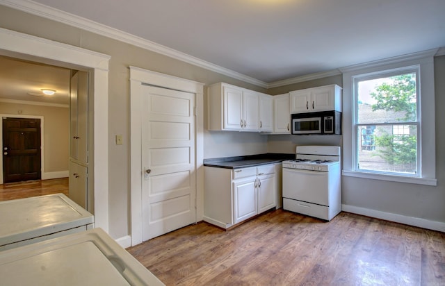 kitchen featuring crown molding, stainless steel microwave, light wood-style floors, white cabinets, and white range with gas cooktop