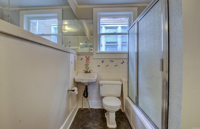 full bathroom featuring ornamental molding, plenty of natural light, toilet, and tile walls