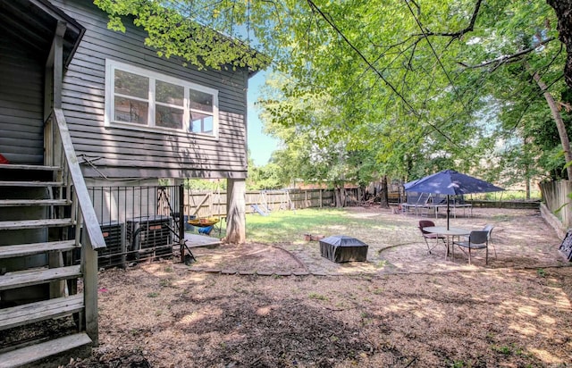 view of yard with a trampoline and a fenced backyard