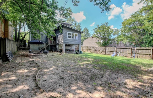 view of yard with stairway and a fenced backyard