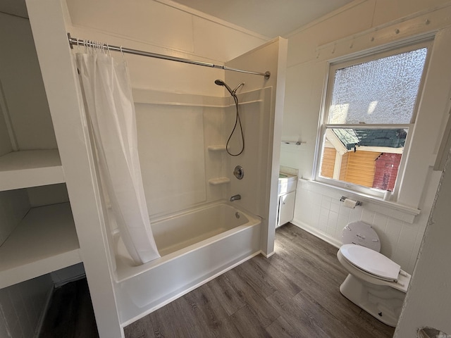 bathroom featuring tile walls, shower / bathtub combination with curtain, toilet, wainscoting, and wood finished floors