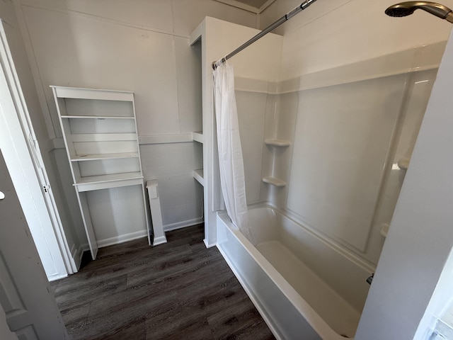 bathroom with shower / bath combination with curtain and wood finished floors