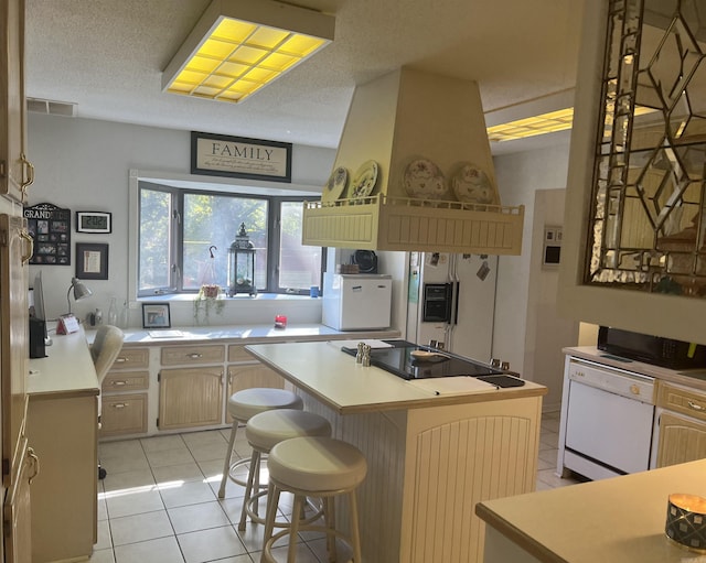 kitchen featuring light tile patterned floors, a textured ceiling, light countertops, a center island, and dishwasher