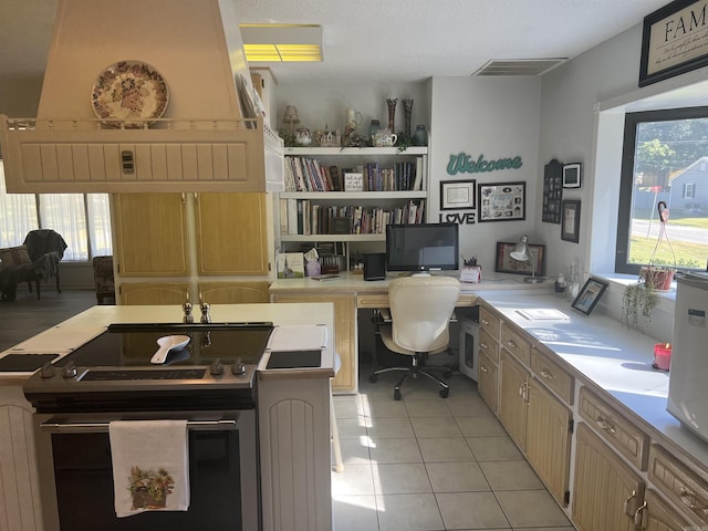 office featuring light tile patterned flooring, built in study area, and visible vents