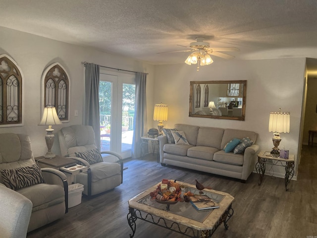 living room with a textured ceiling, wood finished floors, and a ceiling fan