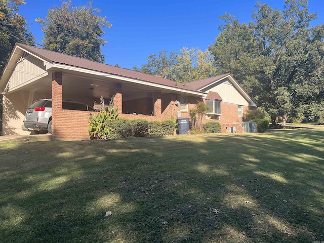 view of property exterior with metal roof, a lawn, and brick siding