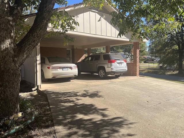 view of vehicle parking featuring driveway and a carport