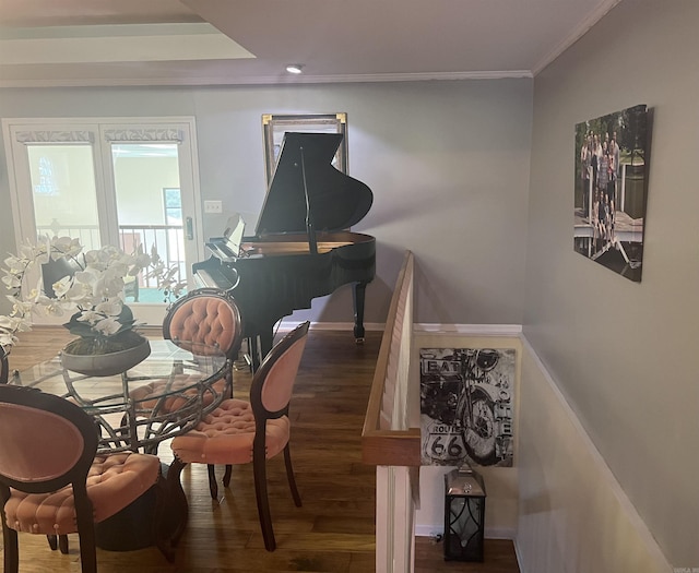 interior space featuring ornamental molding, baseboards, and wood finished floors