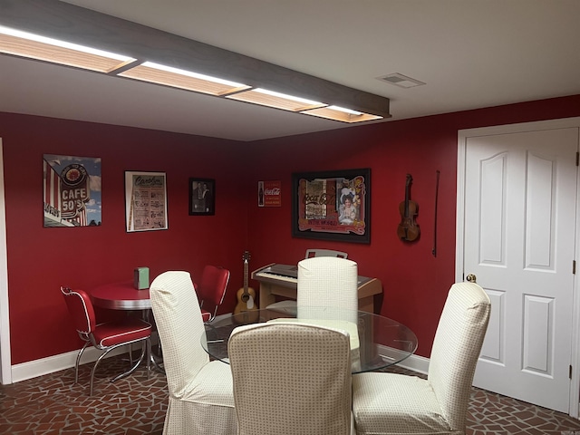 dining room featuring baseboards and visible vents