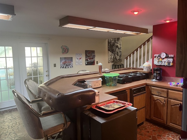 kitchen featuring light countertops and brown cabinets