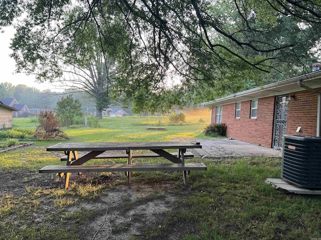 view of yard featuring central AC and a patio