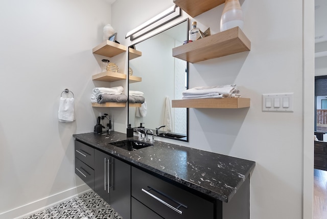 bar with a sink and baseboards