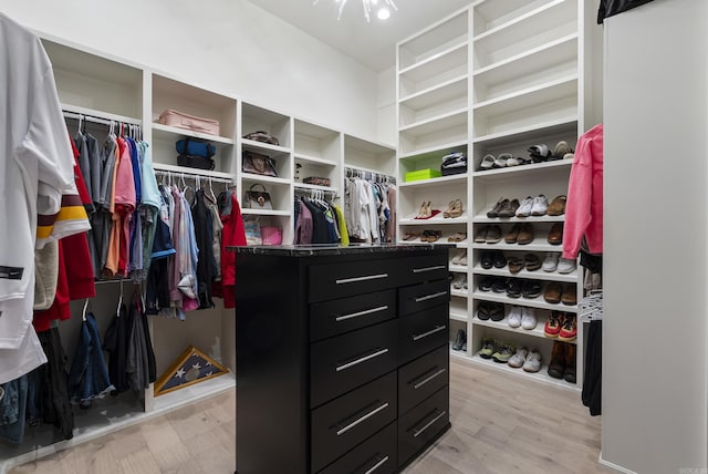 walk in closet with light wood-style flooring