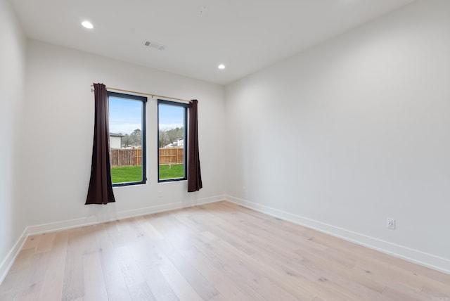 spare room with recessed lighting, baseboards, visible vents, and light wood finished floors