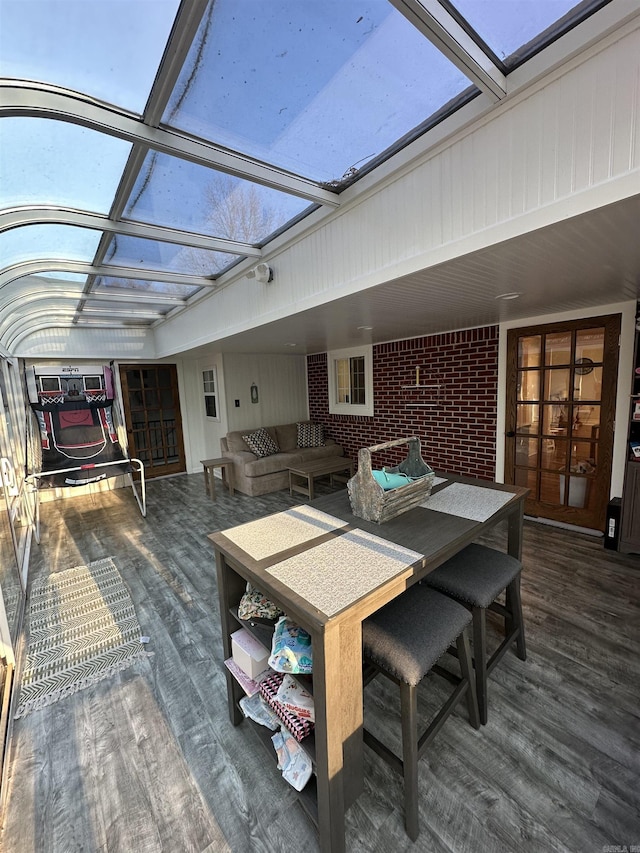 wooden terrace featuring glass enclosure and an outdoor living space