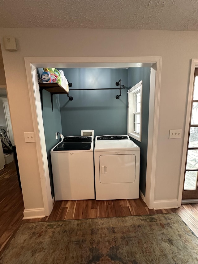 laundry area featuring laundry area, a textured ceiling, separate washer and dryer, and dark wood finished floors