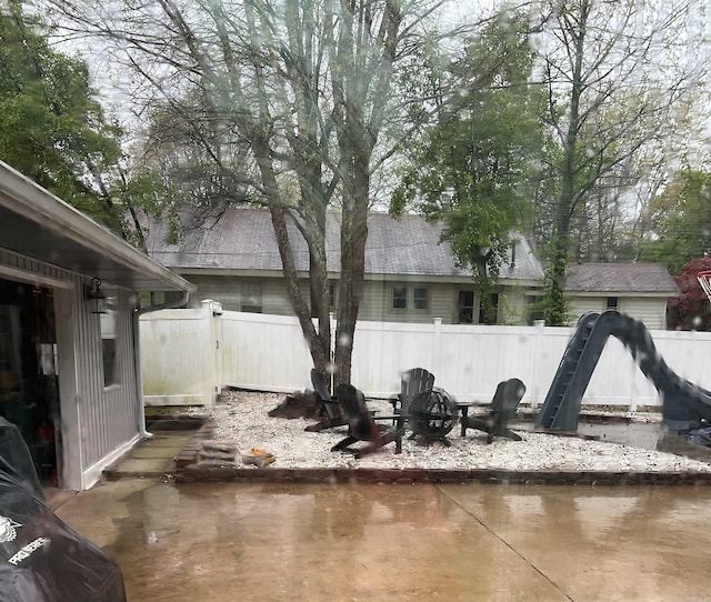 exterior space with a fire pit, a patio, and fence