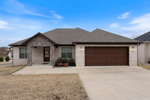 view of front of property featuring an attached garage, brick siding, concrete driveway, and roof with shingles