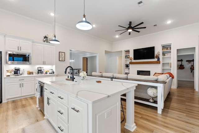 kitchen with stainless steel appliances, light wood-type flooring, visible vents, and a sink