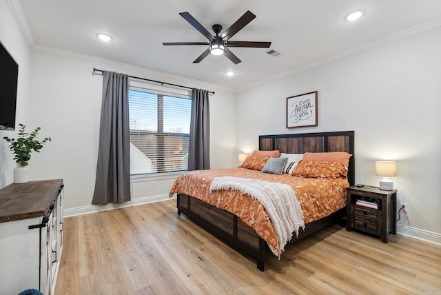 bedroom with light wood-type flooring, baseboards, visible vents, and crown molding