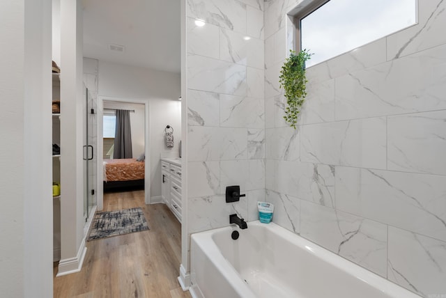 full bath featuring baseboards, visible vents, ensuite bath, and wood finished floors