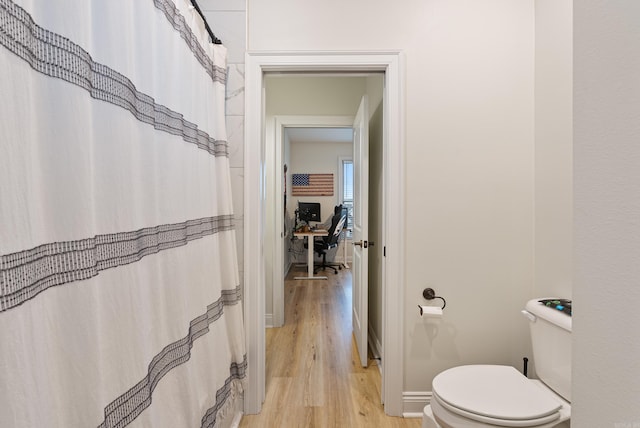 full bath featuring baseboards, toilet, and wood finished floors