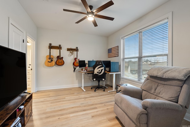 office featuring light wood-style flooring, baseboards, and a ceiling fan