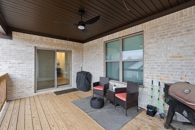 wooden deck featuring ceiling fan and grilling area