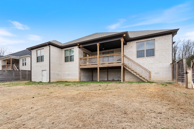 rear view of house with brick siding, fence, stairs, roof with shingles, and crawl space