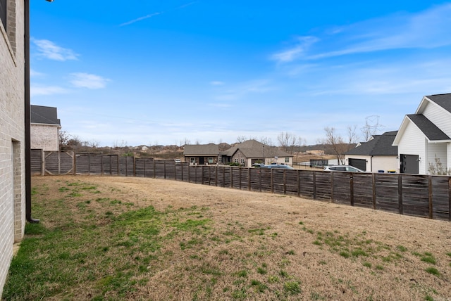 view of yard with fence and a residential view