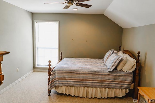 carpeted bedroom with vaulted ceiling, a ceiling fan, and baseboards