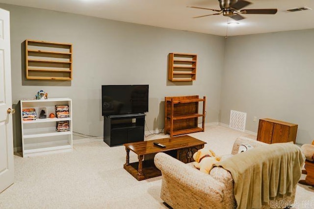 living area with visible vents, a ceiling fan, and carpet flooring