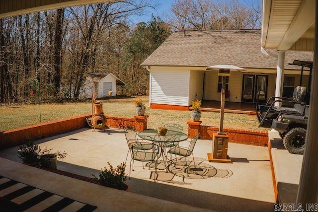 view of patio featuring an outbuilding and french doors