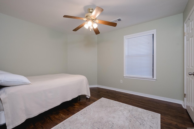 bedroom featuring visible vents, dark wood finished floors, and baseboards