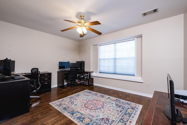 home office with baseboards, visible vents, ceiling fan, and wood finished floors