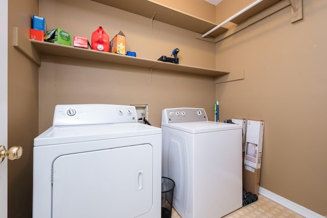 laundry area featuring laundry area, baseboards, separate washer and dryer, and light floors