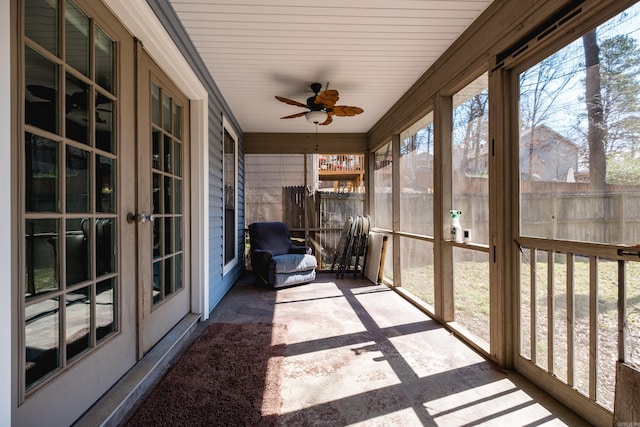 unfurnished sunroom featuring a ceiling fan