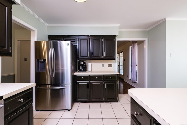 kitchen featuring light tile patterned floors, light countertops, ornamental molding, dark cabinetry, and stainless steel fridge with ice dispenser