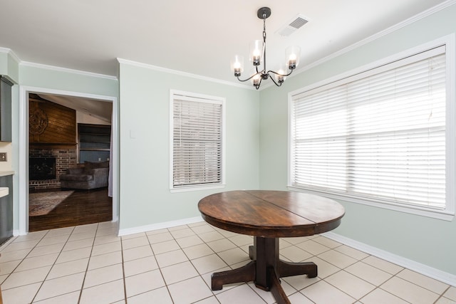 dining space featuring light tile patterned floors, baseboards, visible vents, ornamental molding, and a fireplace